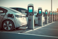 a group of electric cars parked in a parking lot