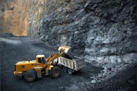 a bulldozer is working in a coal mine